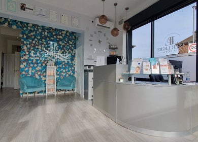 Reception area of Laser Light Skin Clinic in Dagenham, England, GB with blue floral wall and brochures.