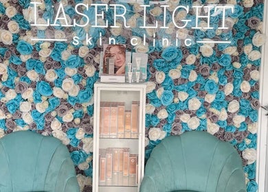 Elegant floral wall at Laser Light Skin Clinic, Dagenham, England, GB with a display of skincare products.