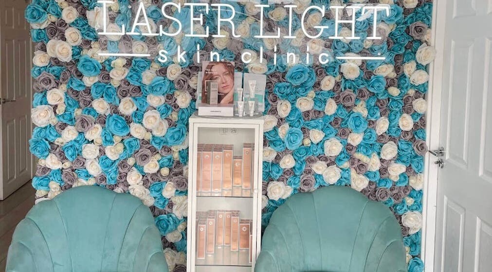 Elegant floral wall at Laser Light Skin Clinic, Dagenham, England, GB with a display of skincare products.