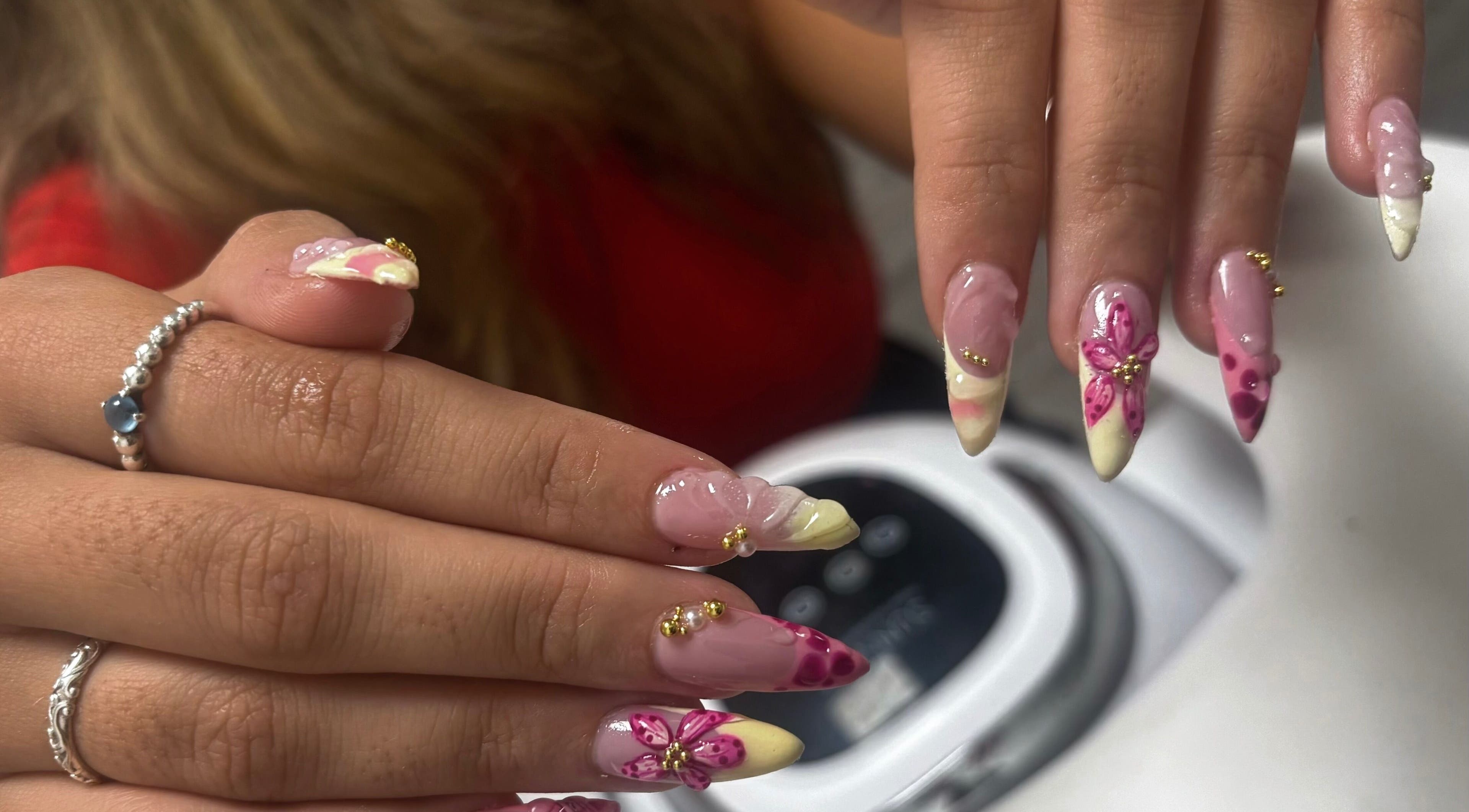 Artful nail designs at All About the Nails, Northallerton, England, GB. Features pink floral details.