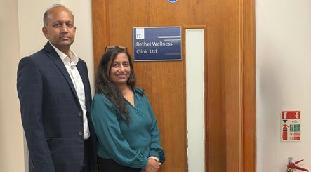 Staff at Bethel Wellness Clinic entrance, Kings Hill, England, GB, welcoming with smiles.