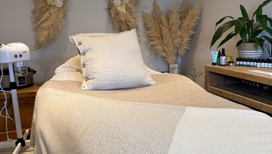 Cozy treatment room at The Wellness Pod in Woodborough, England, GB with neutral decor and wellness products.