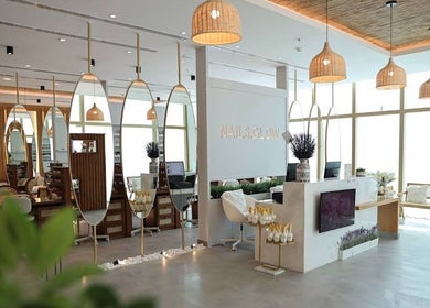 Chic interior of Nails Glow - Ar Rabwah in Riyadh, Riyadh Province, SA with stylish mirrors and lighting.