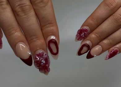 Elegant nail art at IB NAILZ, Edinburgh, Scotland, GB featuring intricate red and nude designs with floral accents.