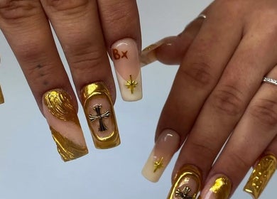 Intricate gold nail art at IB NAILZ, Edinburgh, Scotland, GB offers luxury and style with detailed embellishments.