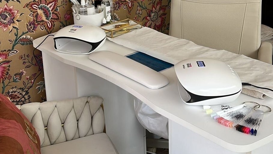 Modern nail station at The Nail Nook in Townhill, Wales, GB featuring sleek design and floral wallpaper.