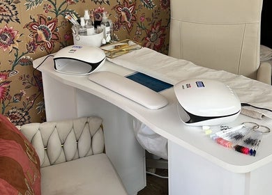 Modern nail station at The Nail Nook in Townhill, Wales, GB featuring sleek design and floral wallpaper.