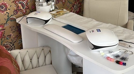 Modern nail station at The Nail Nook in Townhill, Wales, GB featuring sleek design and floral wallpaper.