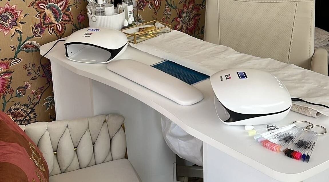 Modern nail station at The Nail Nook in Townhill, Wales, GB featuring sleek design and floral wallpaper.