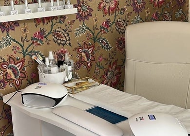 Chic nail art station at The Nail Nook, Townhill, Wales, GB, featuring elegant tools and floral decor.