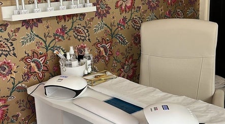 Chic nail art station at The Nail Nook, Townhill, Wales, GB, featuring elegant tools and floral decor.
