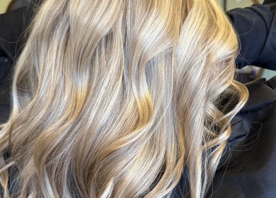 Blonde, wavy hair styled at Hair By Karolina in Bolton, England, GB. Perfect for a radiant and elegant look.