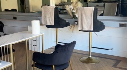 Chic seating area inside Heavenly Hideaway, Leeds, England, GB, with plush chairs and stylish decor.