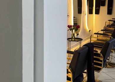 Modern salon chairs at The Royal house, Emalahleni, Mpumalanga, ZA, with elegant lighting and decor.