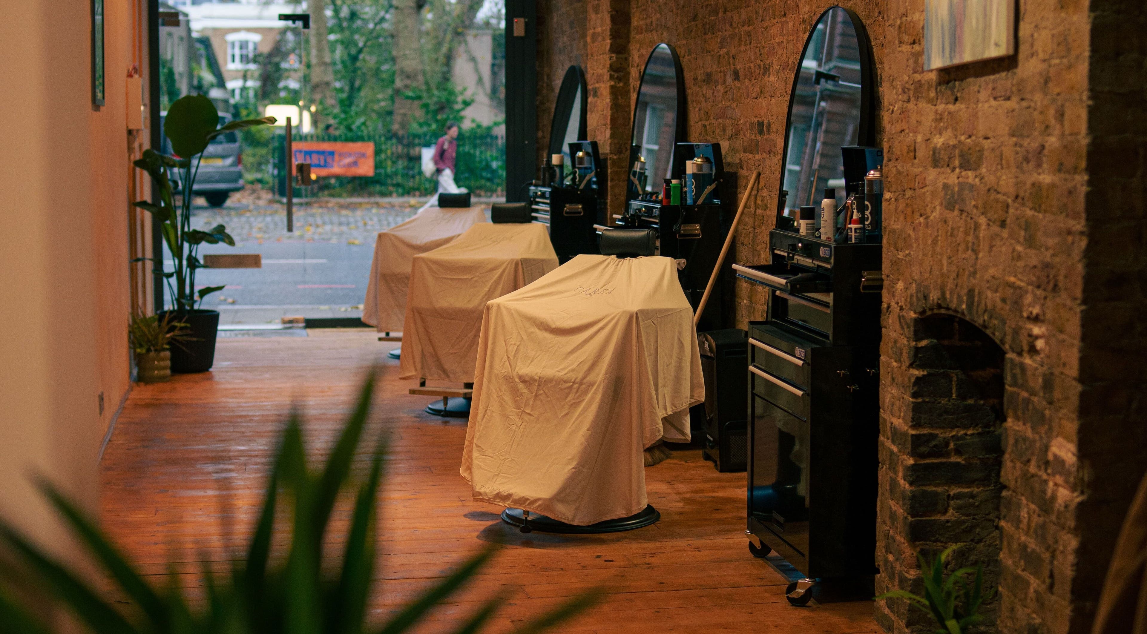 Elegant interior of Parea London salon, with covered styling chairs in London, England, GB.
