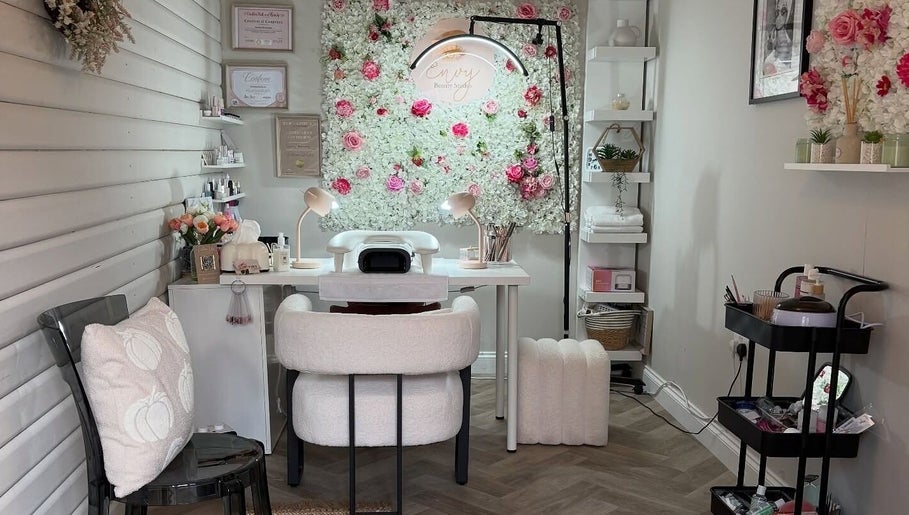 Relaxing salon setup at Envy Beauty Studio, Scarborough, England, with floral decor and cozy seating.