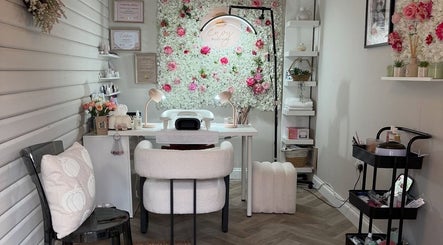 Relaxing salon setup at Envy Beauty Studio, Scarborough, England, with floral decor and cozy seating.