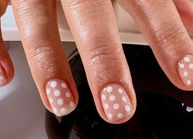 Stylish polka dot nail art at Envy Beauty Studio, Scarborough, England, GB showcasing vibrant creativity.