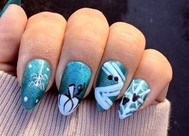 Intricate blue nail art design at Envy Beauty Studio, Scarborough, England, GB, featuring spider and web details.