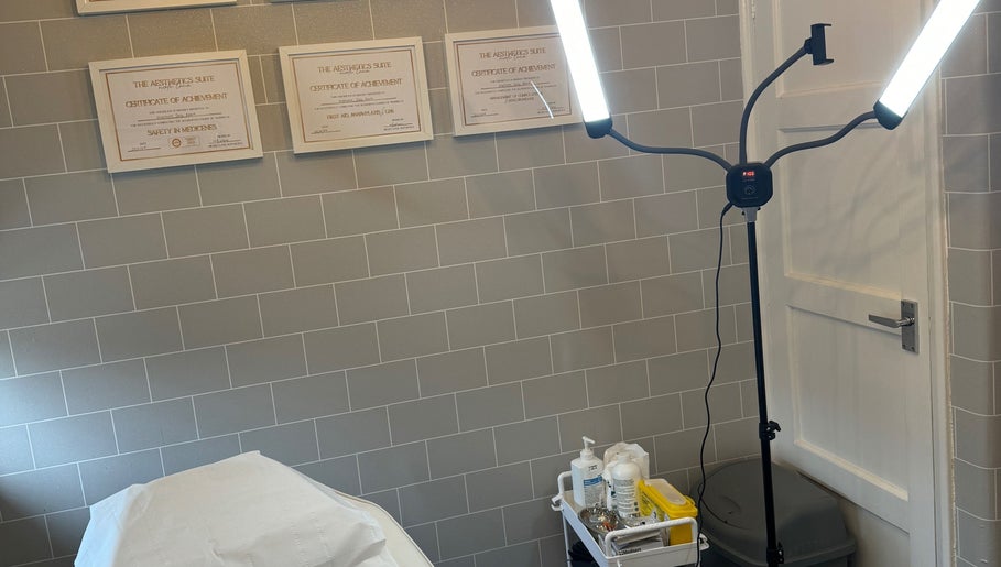 Tranquil treatment room at Daly Aesthetics, Little Hulton, England, featuring modern lighting and skincare products.