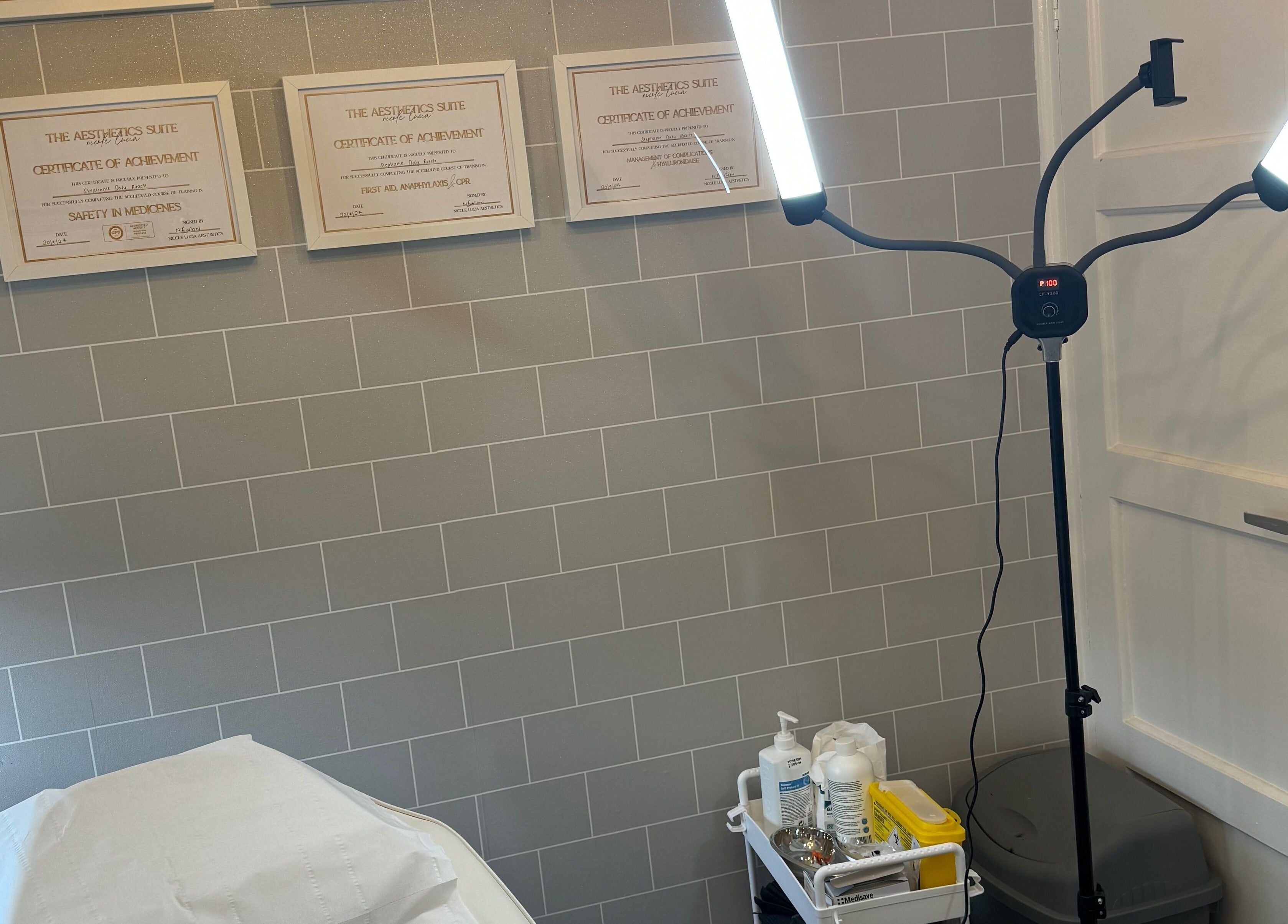 Tranquil treatment room at Daly Aesthetics, Little Hulton, England, featuring modern lighting and skincare products.