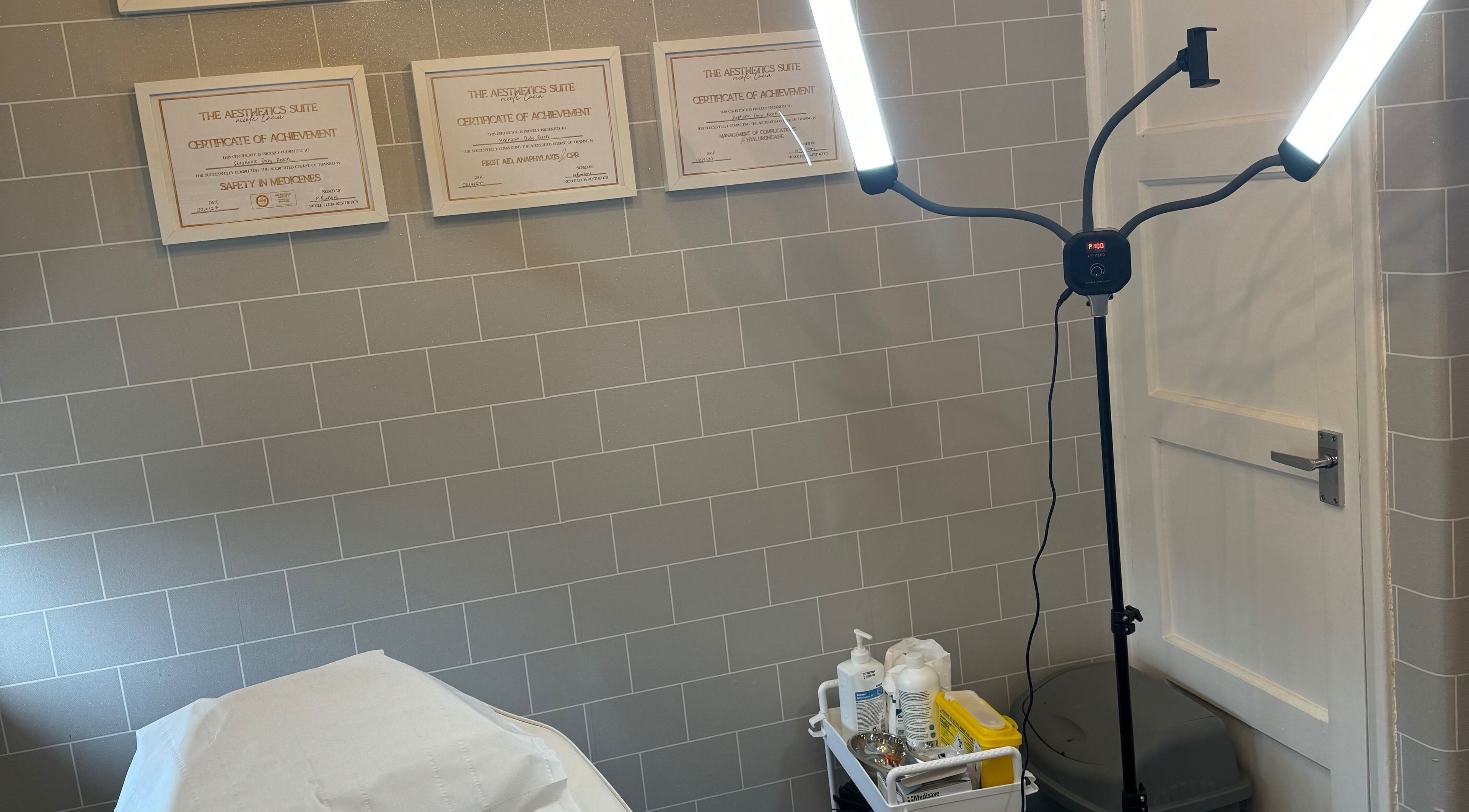 Tranquil treatment room at Daly Aesthetics, Little Hulton, England, featuring modern lighting and skincare products.