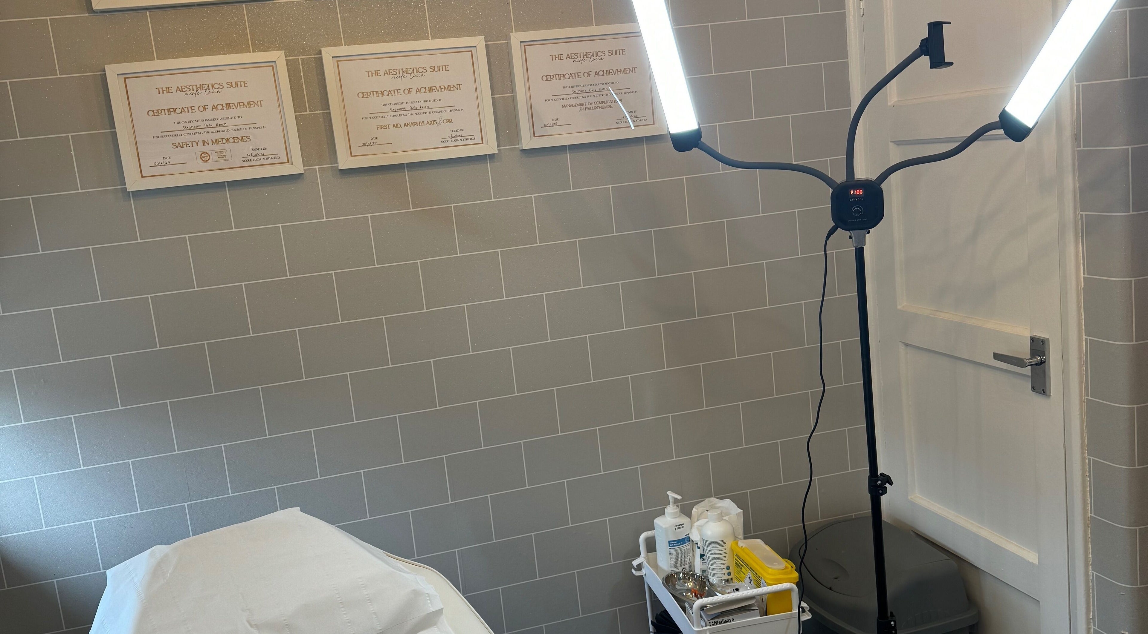 Tranquil treatment room at Daly Aesthetics, Little Hulton, England, featuring modern lighting and skincare products.