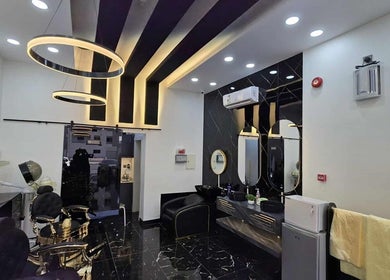 تصميم أنيق لمحل Safety Scissors Barbershop في الرياض، SA مع مرايا وإضاءة عصرية.