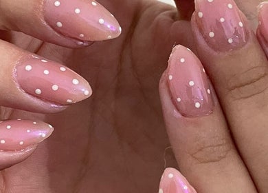 Uñas decoradas con esmalte rosa y puntos blancos en Afrodita Estética, Rosario, Santa Fe, AR.