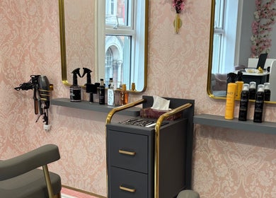 Elegant hairstyling station at Ane Hair Cork, Cork, County Cork, IE with a stylish pink backdrop.