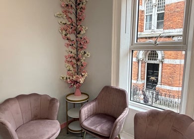Elegant seating with pink chairs and floral decor at Ane Hair Cork, Cork, County Cork, IE.