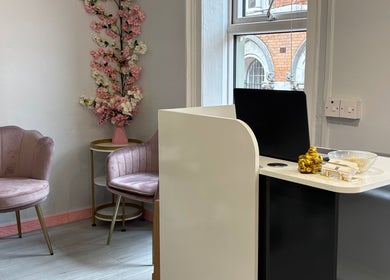 Chic waiting area at Ane Hair Cork, Cork, County Cork, IE with plush pink chairs and floral decor.