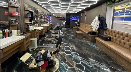 Modern barbershop interior at Style Cutz, Ilkeston, England, GB, featuring hexagonal lighting and sleek furnishings.