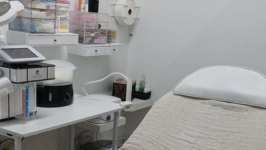 Modern treatment room at Beauty Fits All, Florida, Florida, US, featuring a comfortable bed and equipment.