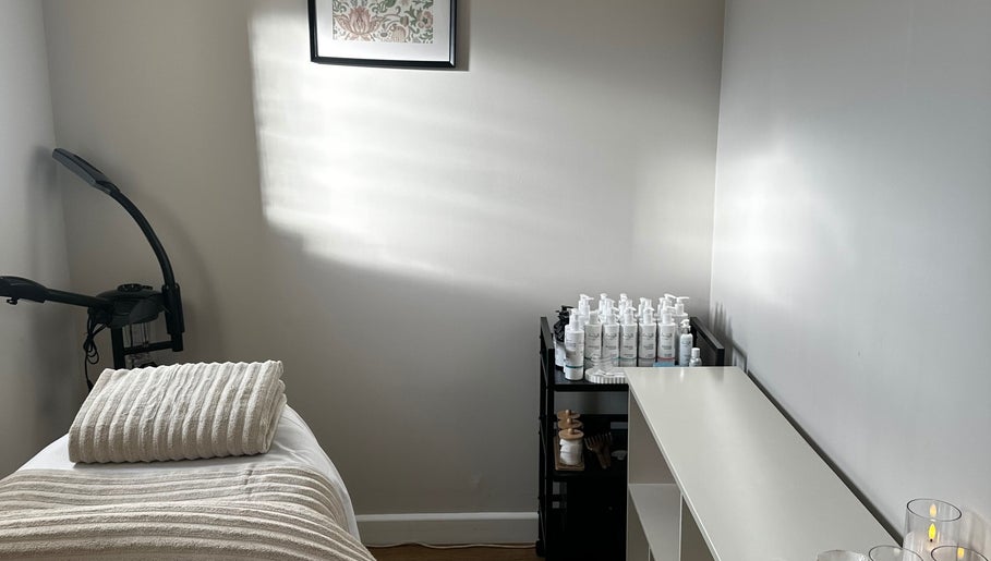 Calming treatment room at Beauty by Claudie with cozy bed, products, and decor in Gamlingay, England, GB.