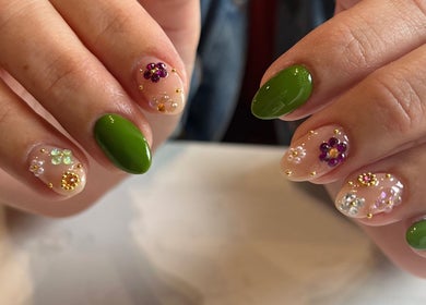 Colorful floral nail art with green accents at Speakeasy Nail Studio, Lynnwood, Washington, US.
