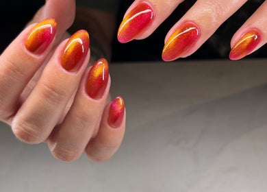 Bright orange and red ombre nails at Speakeasy Nail Studio, Lynnwood, Washington, US.