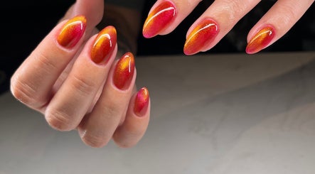Bright orange and red ombre nails at Speakeasy Nail Studio, Lynnwood, Washington, US.