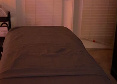 Relaxing treatment room at Imperfect Beauty Bar, Grand Prairie, Texas, US, featuring a cozy massage bed.