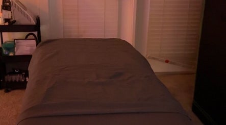 Relaxing treatment room at Imperfect Beauty Bar, Grand Prairie, Texas, US, featuring a cozy massage bed.