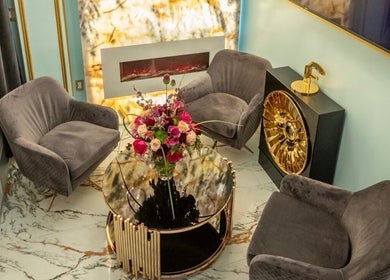 Chic waiting area at San Michel The Legend Barbershop, Glendale, California, US, featuring plush chairs and floral decor.