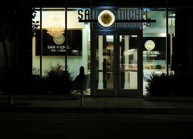 Night view of San Michel The Legend Barbershop in Glendale, California, US with illuminated sign.