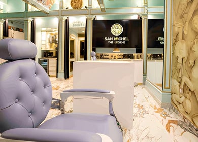 Elegant interior of San Michel The Legend Barbershop, Glendale, California, US with plush seating and decor.