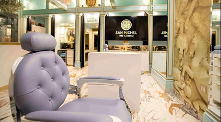 Elegant interior of San Michel The Legend Barbershop, Glendale, California, US with plush seating and decor.