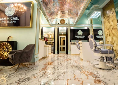 Luxurious interior of San Michel The Legend Barbershop in Glendale, California, with ornate decor and seating.