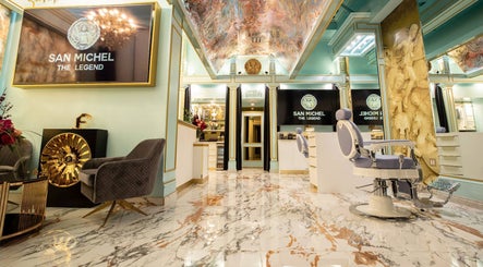 Luxurious interior of San Michel The Legend Barbershop in Glendale, California, with ornate decor and seating.