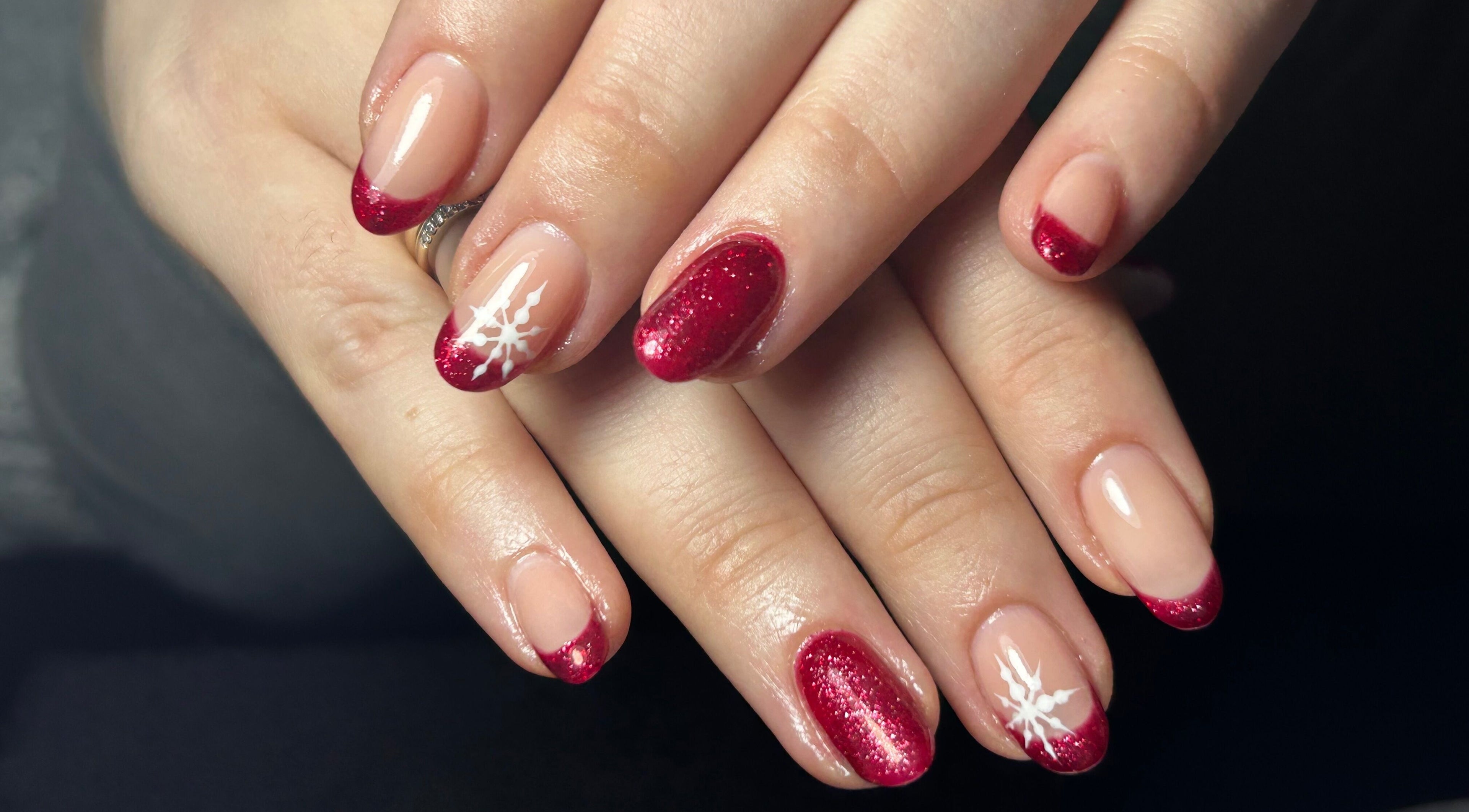 Elegant red nail art featuring snowflakes at Beautify by Anakim, Longrock, England, GB.