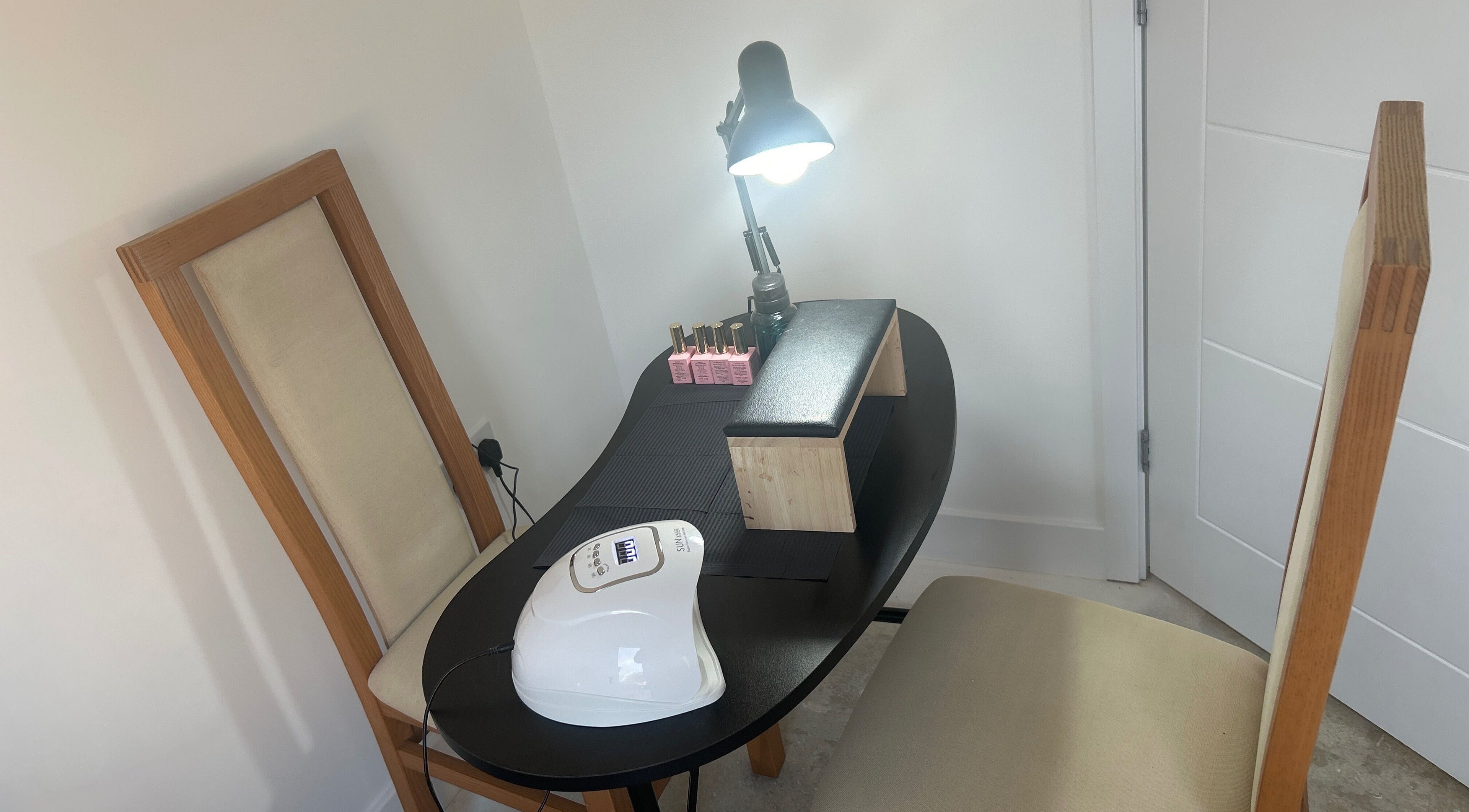 Nail care setup at Beautify by Anakim, Longrock, England, GB. Featuring lamps, polishes, and chairs.