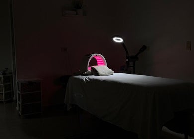 Dimly lit therapy room at Cabo Glow Salon, San José Del Cabo, Baja California Sur, MX featuring a treatment bed.