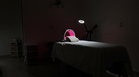 Dimly lit therapy room at Cabo Glow Salon, San José Del Cabo, Baja California Sur, MX featuring a treatment bed.